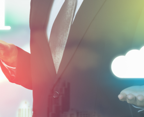 Business professional in a suit holding icons representing growth and cloud technology, highlighting the benefits of Dallas VoIP phone systems.