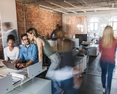 A team collaborating in an office using video conferencing, illustrating the role of business VoIP providers in Dallas in enhancing communication.