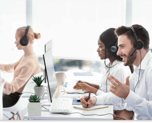 Customer service representatives using VoIP headsets in an office setting, demonstrating the efficiency of VoIP technology in Dallas.