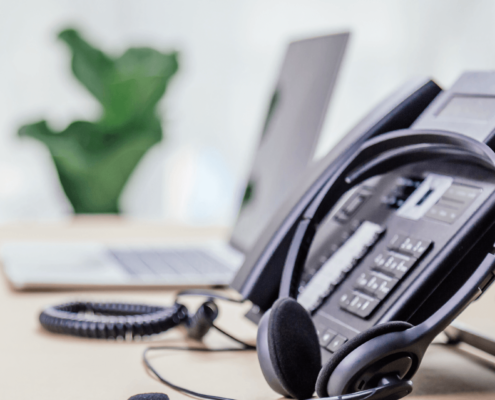 A modern office desk featuring a sophisticated VoIP phone system, highlighting the advanced communication technology used by businesses in Dallas. Keyword: voip phone systems dallas